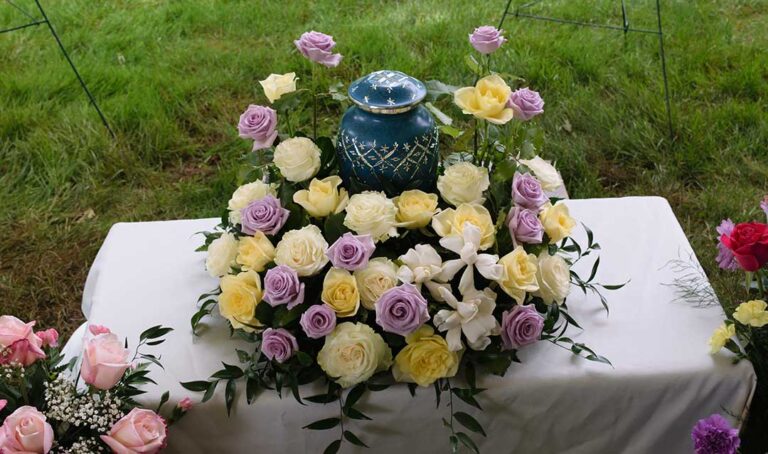 A person standing at a lectern reading from a sheet of paper during a funeral service.